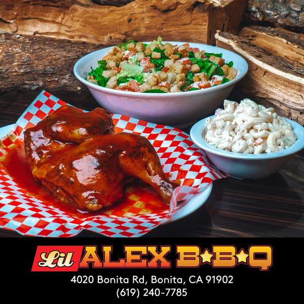 Lil Alex BBQ chicken with sauce, macaroni salad, and green salad against a woodpile background.