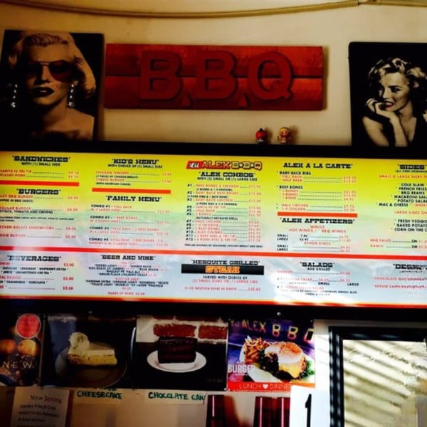 Lil Alex BBQ menu board with Marilyn Monroe images, food items, prices, and desserts.